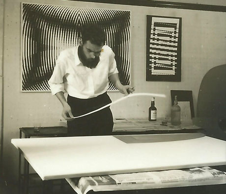 Jeffrey Steele artist with paper measuring strip in Penylan studio late 1960s Peziza and Talviaurinko on wall