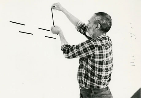 Jeffrey Steele artist making work on exhibition wall